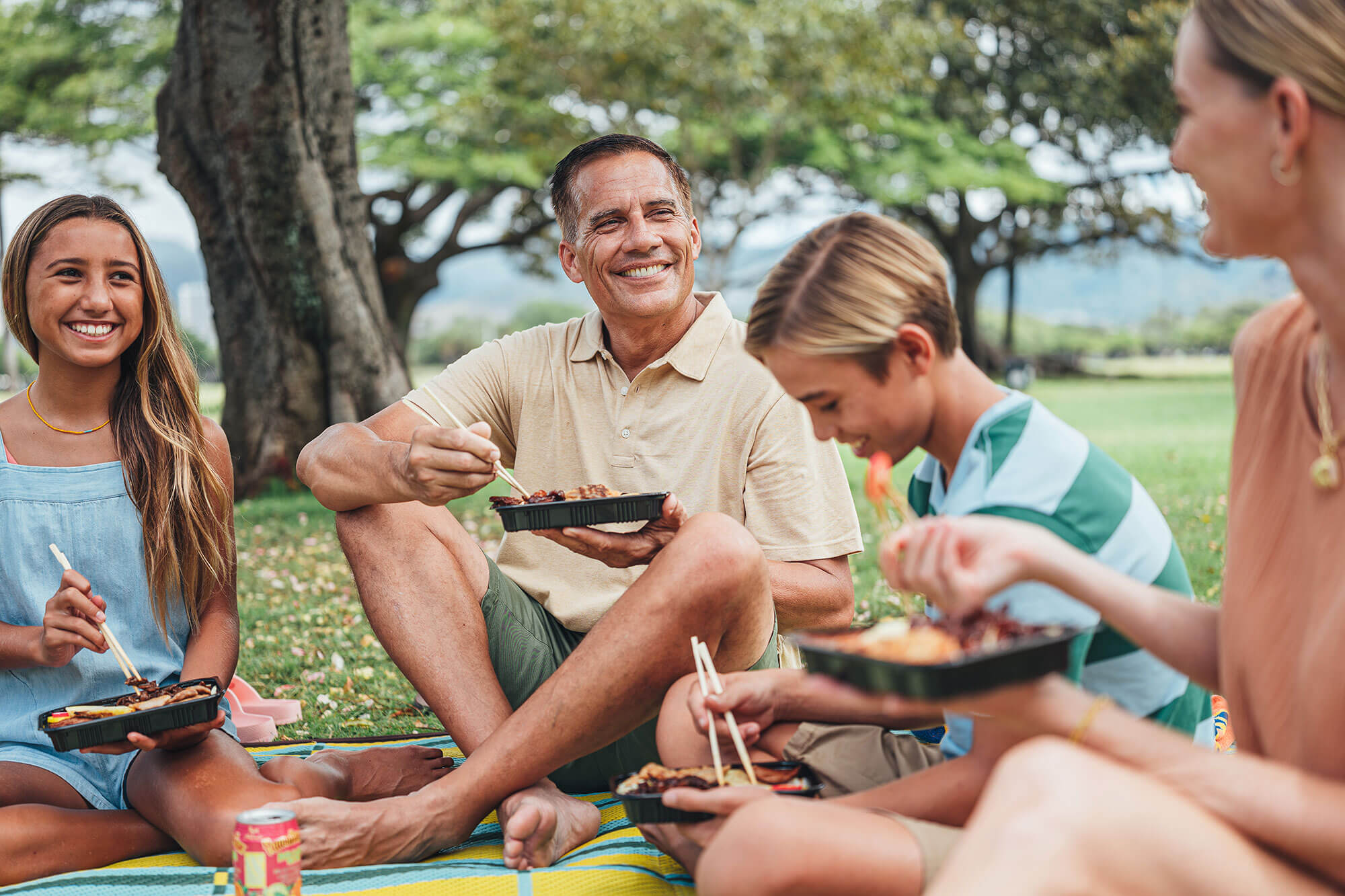 Family enjoying a picnic at the park